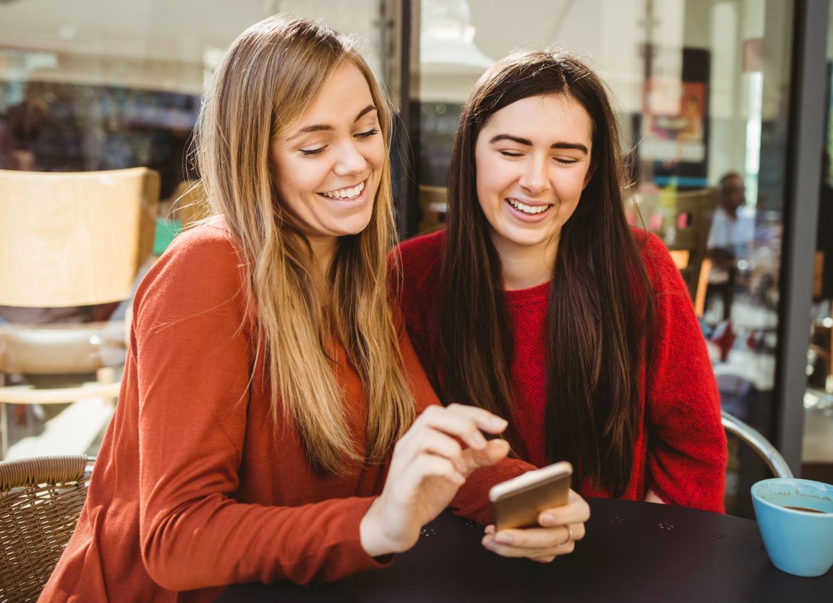 Two female friends looking at a smartphone