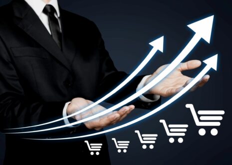 Businessman in suit showing graph that depicts online sales growth