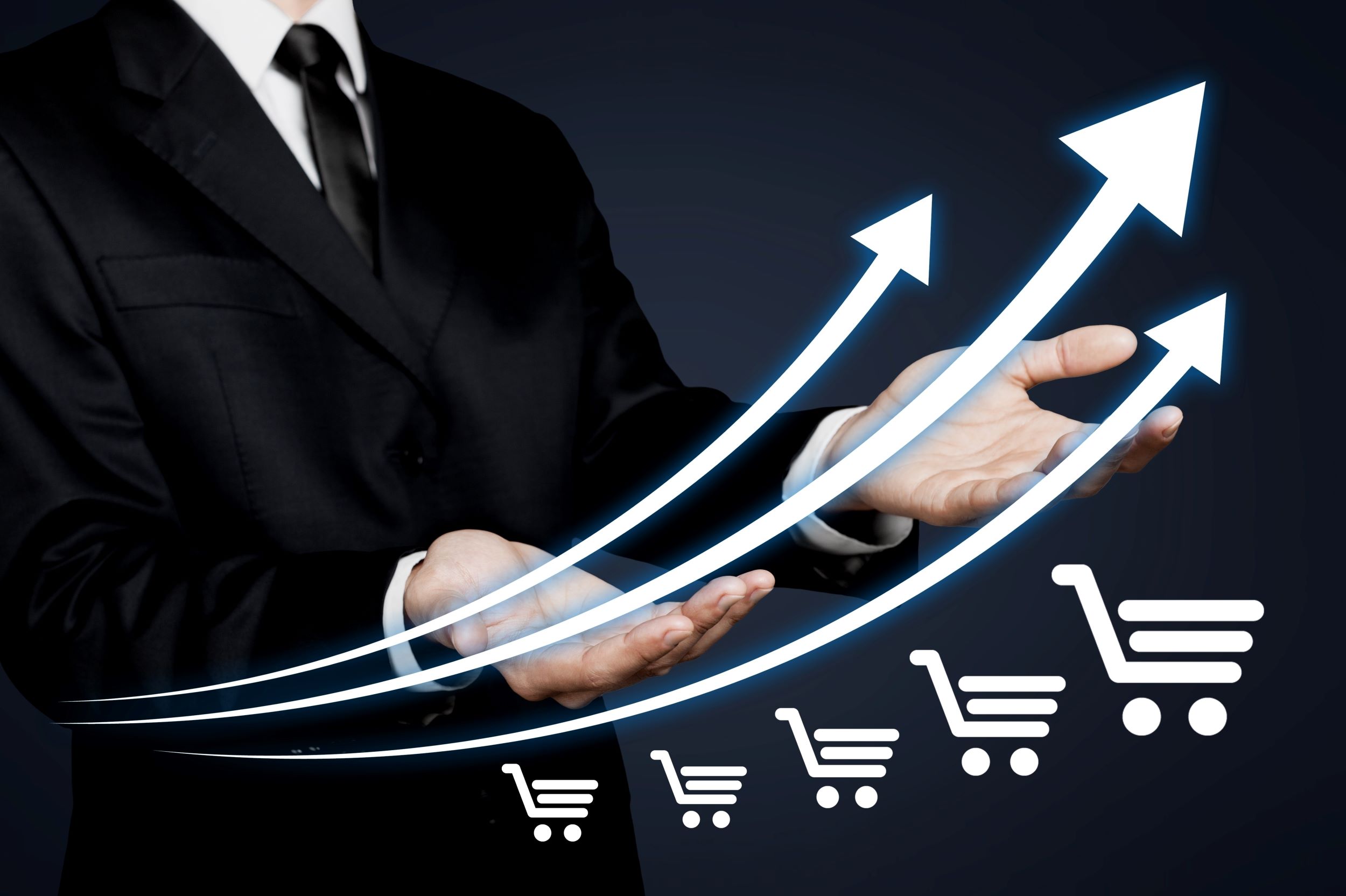 Businessman in suit showing graph that depicts online sales growth