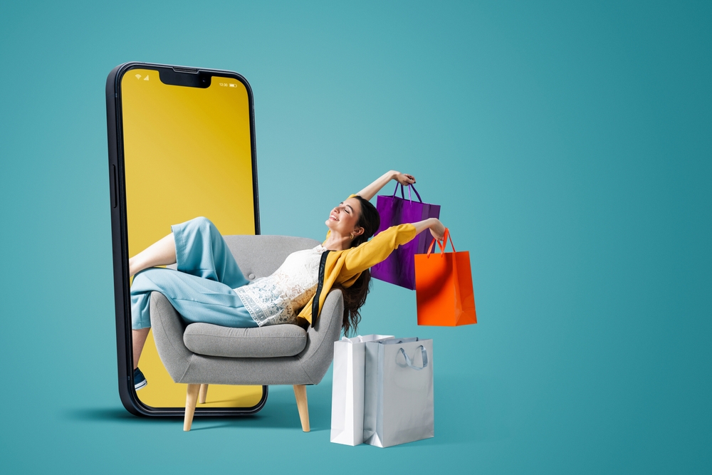 Woman with shopping bags against large mobile phone graphic